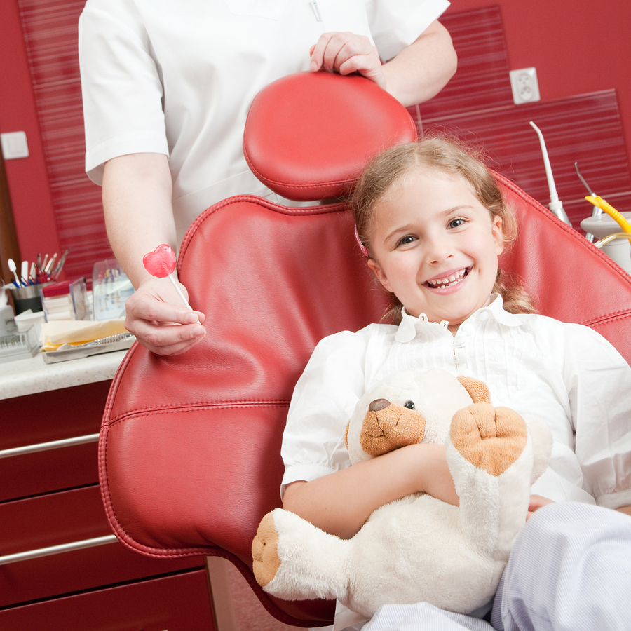 Little girl smiling in a dental chair