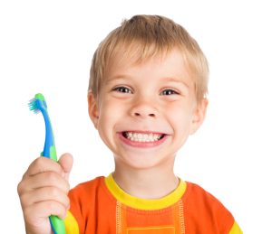 boy smiling with a toothbrush