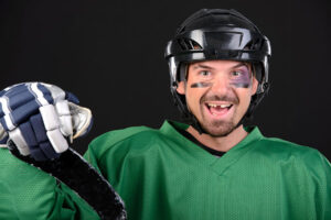 A hockey player smiling with a knocked out tooth