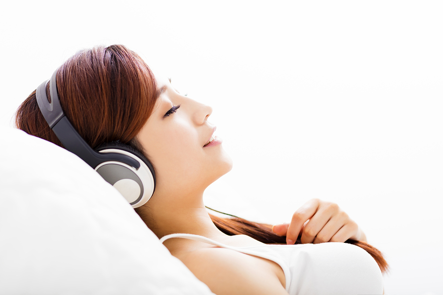 relaxed young Woman with headphones listening music