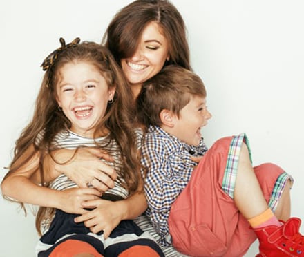 Mom holding her two children